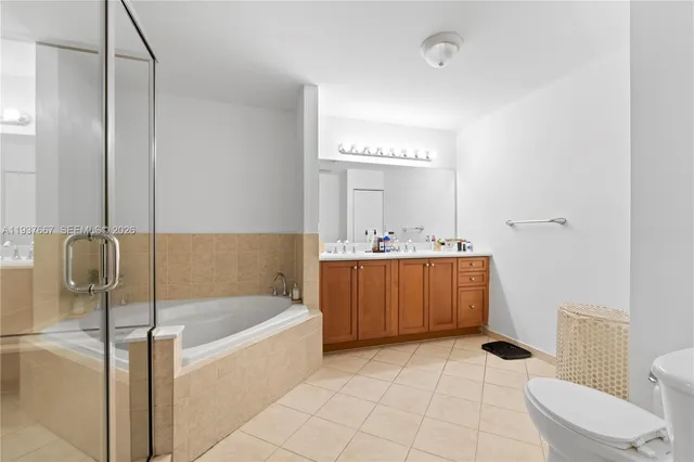 a bathroom with a bathtub sink mirror and toilet