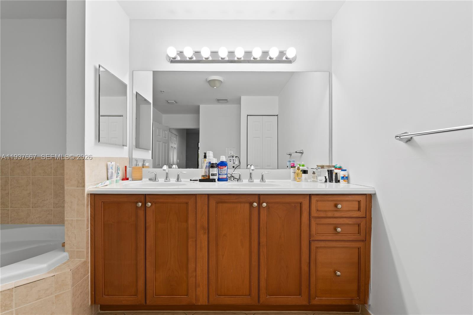 8395 Southwest 73rd Avenue, Unit 115 Miami, FL 33143 - Photo 19 of 26 a bathroom with a sink and a mirror