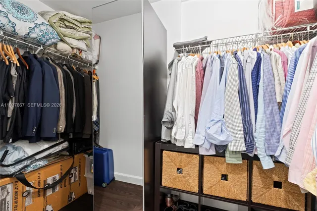 a view of walk in closet with clothes