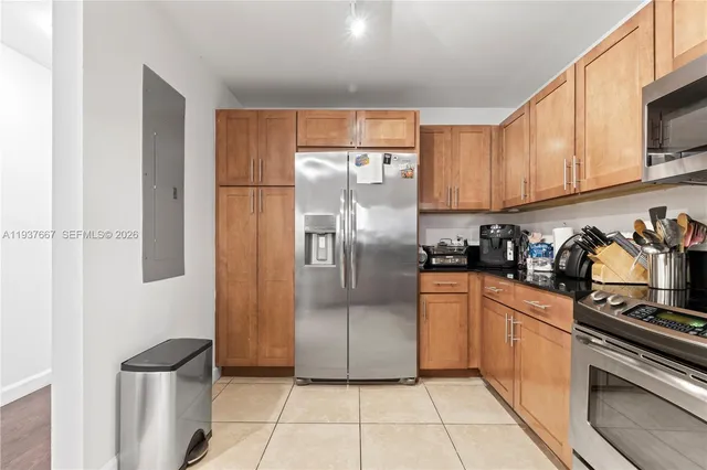 a kitchen with stainless steel appliances granite countertop a refrigerator and a stove