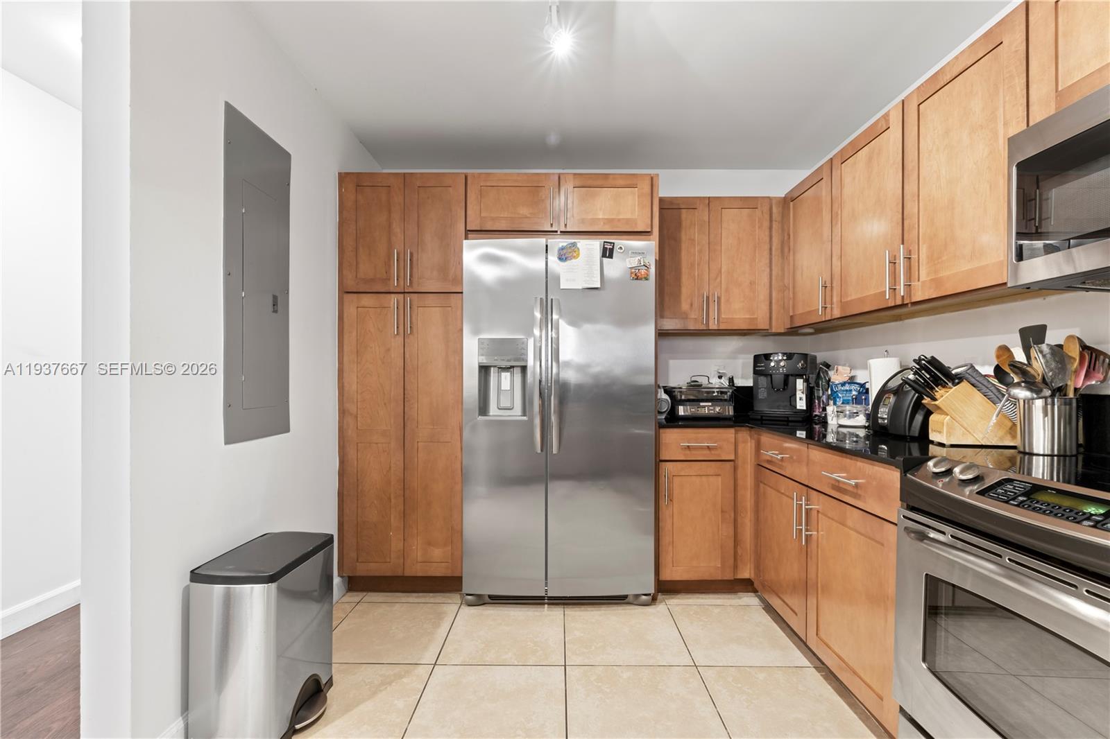 8395 Southwest 73rd Avenue, Unit 115 Miami, FL 33143 - Photo 8 of 26 a kitchen with stainless steel appliances granite countertop a refrigerator and a stove