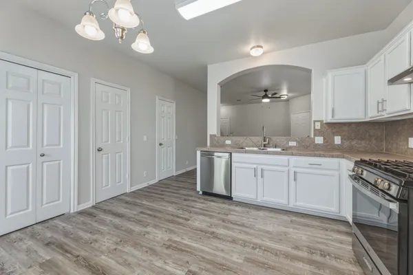 a spacious bathroom with a granite countertop sink a mirror and a vanity
