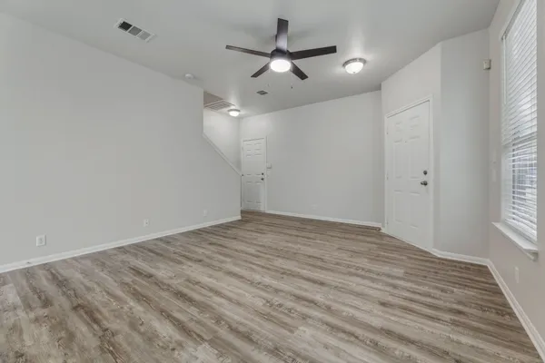 wooden floor in an empty room with a window
