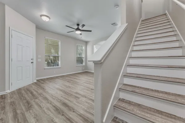 wooden floor in an empty room with a window