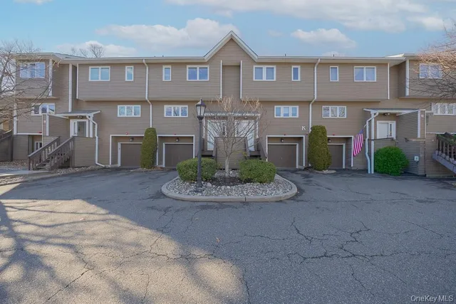 a front view of a residential apartment building with a yard