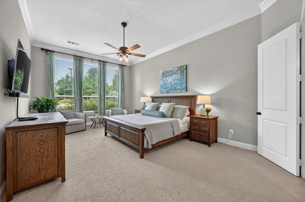 6656 Roughleaf Ridge Road Flower Mound, TX 76226 - Photo 17 of 40 a spacious bedroom with a bed and a flat screen tv