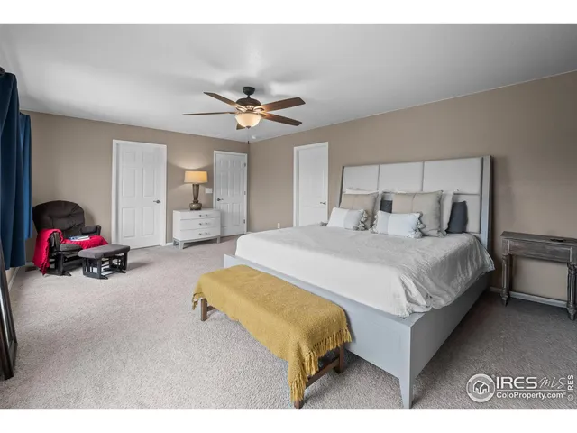 a bedroom with a bed window and a couch