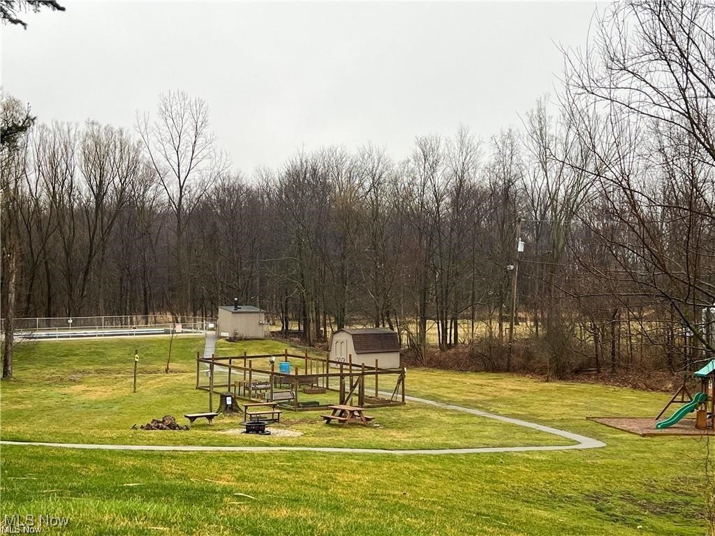 4015 Marks Road, Unit 3C Medina, OH 44256 - Photo 36 of 36 View of home's community featuring a lawn, a storage unit, and a playground