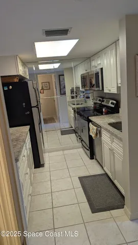 a kitchen with a table chairs and a refrigerator