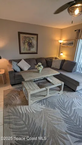 a bed sitting in a bedroom and lamp next to a window