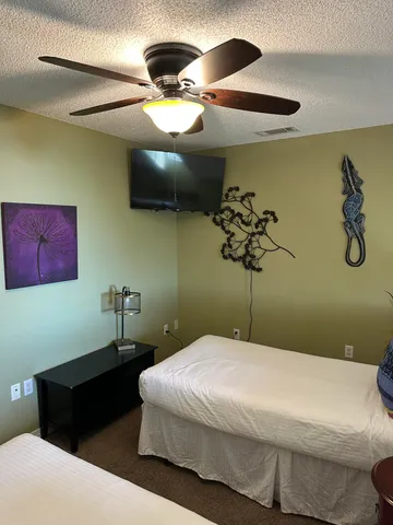 a bedroom with a bed and a chandelier