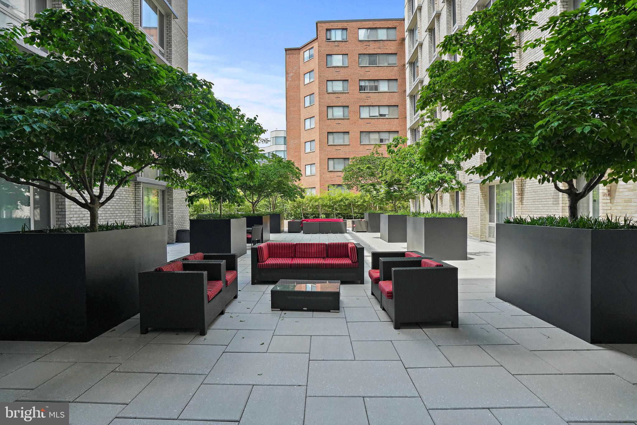 950 25th Street Northwest, Unit 1027N Washington, DC 20037 - Photo 25 of 32 a view of a patio with couches and table and chairs and potted plants