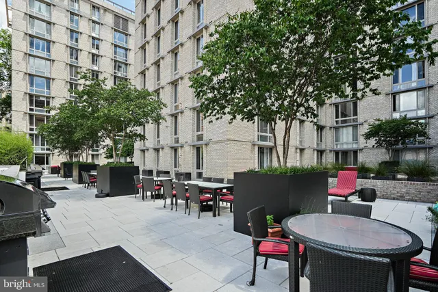 a building outdoor space with patio furniture and potted plants