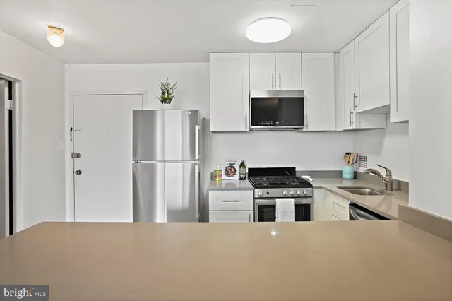 a kitchen with stainless steel appliances granite countertop a refrigerator stove a sink and dishwasher