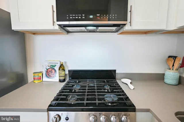 a stove top oven sitting inside of a kitchen