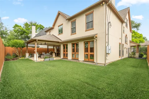 a view of a house with a yard and sitting area