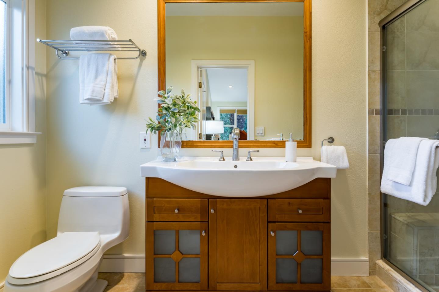 631 La Mesa Drive Portola Valley, CA 94028 - Photo 21 of 27 a bathroom with a sink a toilet and mirror