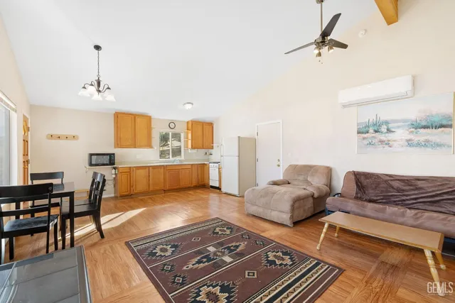 a kitchen with stainless steel appliances granite countertop a sink cabinets and wooden floor