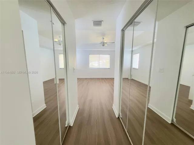 a view of hallway with wooden floor