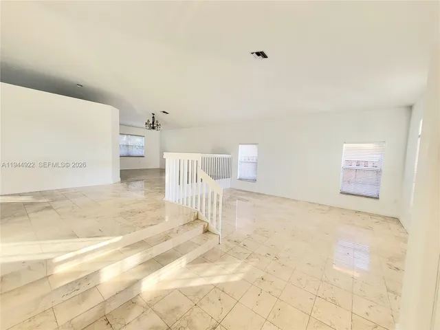 a bathroom with a sink toilet and cabinets