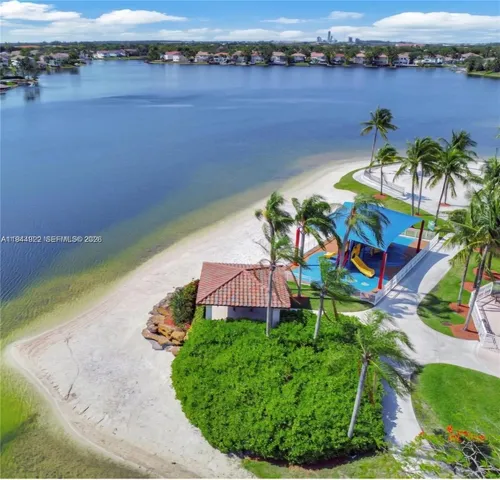 an aerial view of a house with a lake view