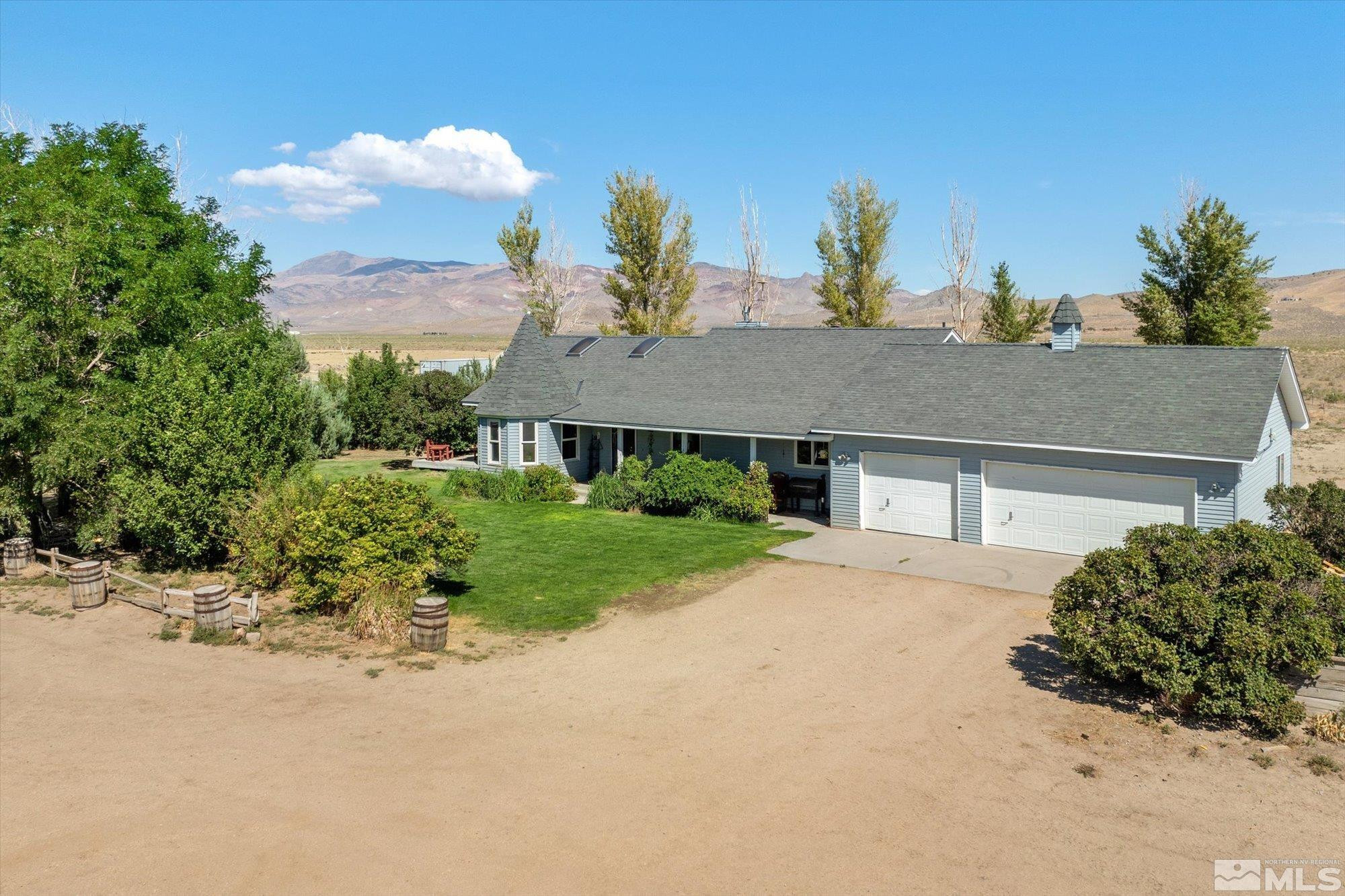 16300 Pyramid Way Reno, NV 89510 - Photo 1 of 36 a front view of a house with a yard and garage