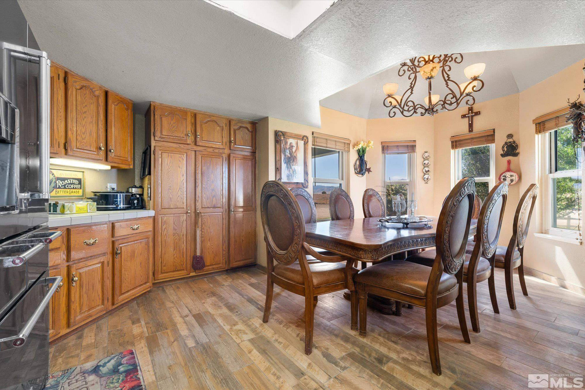 16300 Pyramid Way Reno, NV 89510 - Photo 20 of 36 a view of a dining room with furniture window and wooden floor