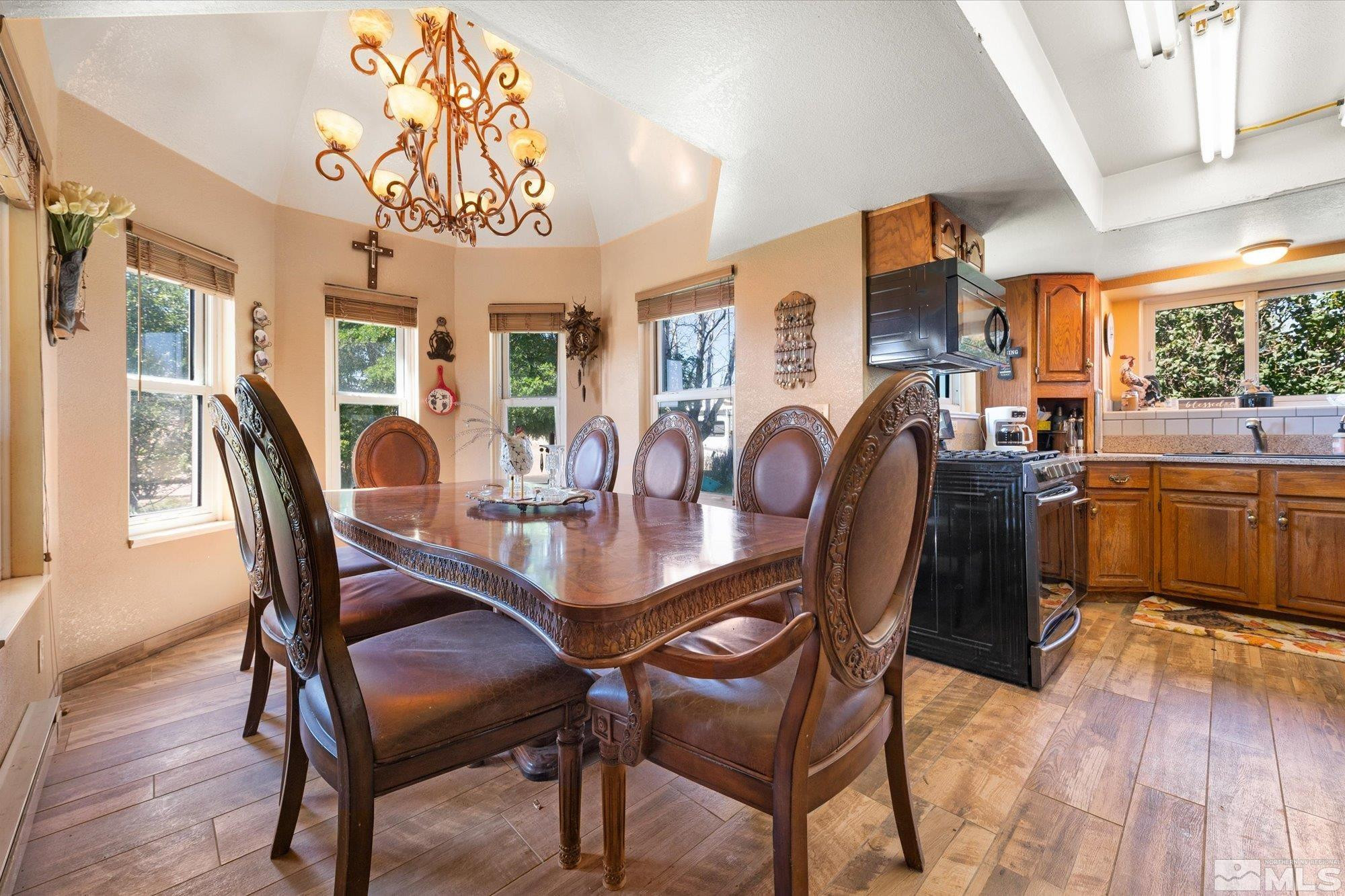 16300 Pyramid Way Reno, NV 89510 - Photo 21 of 36 a dining room with furniture a chandelier and wooden floor