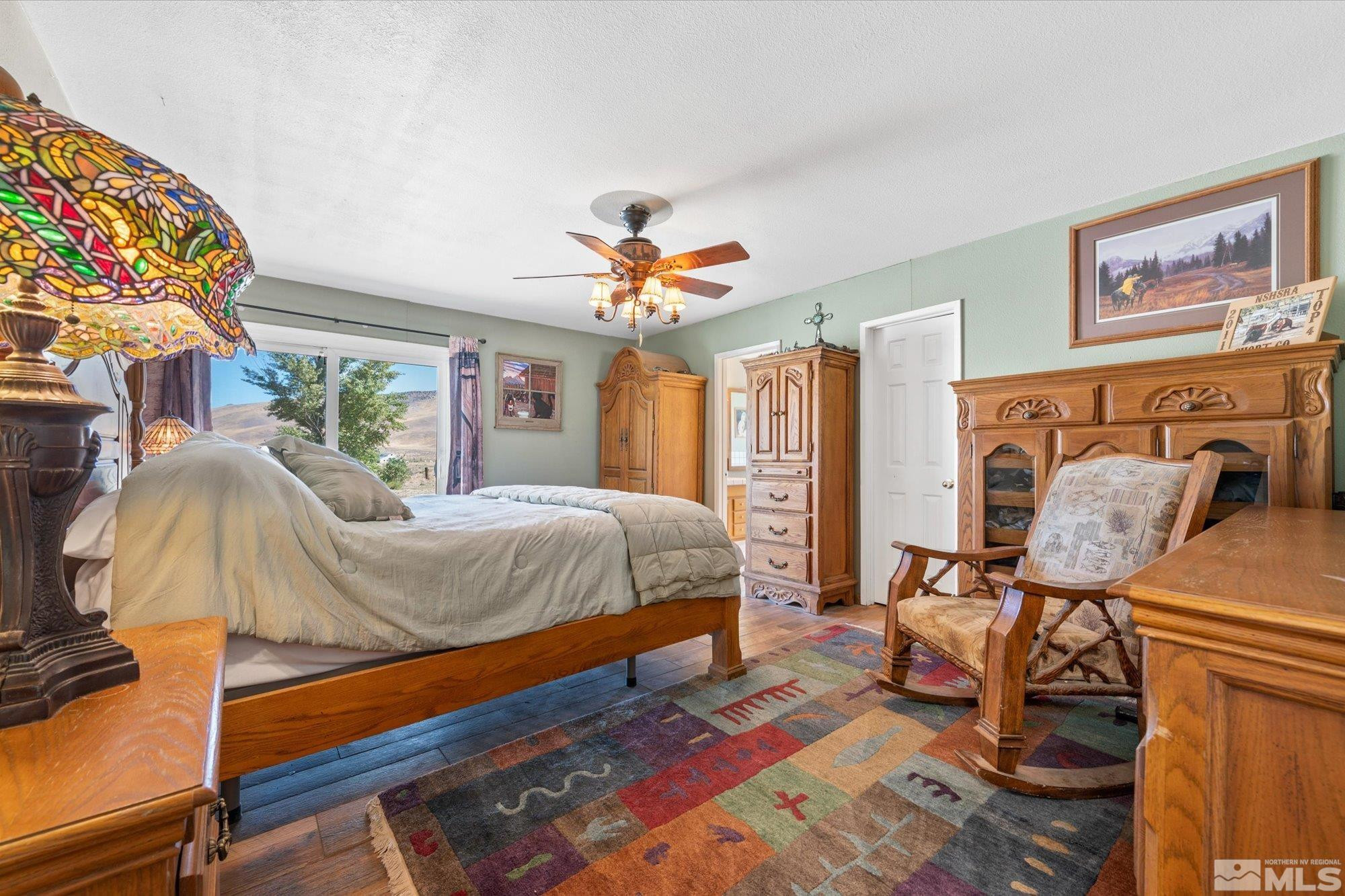 16300 Pyramid Way Reno, NV 89510 - Photo 22 of 36 a bedroom with a bed and wooden floor