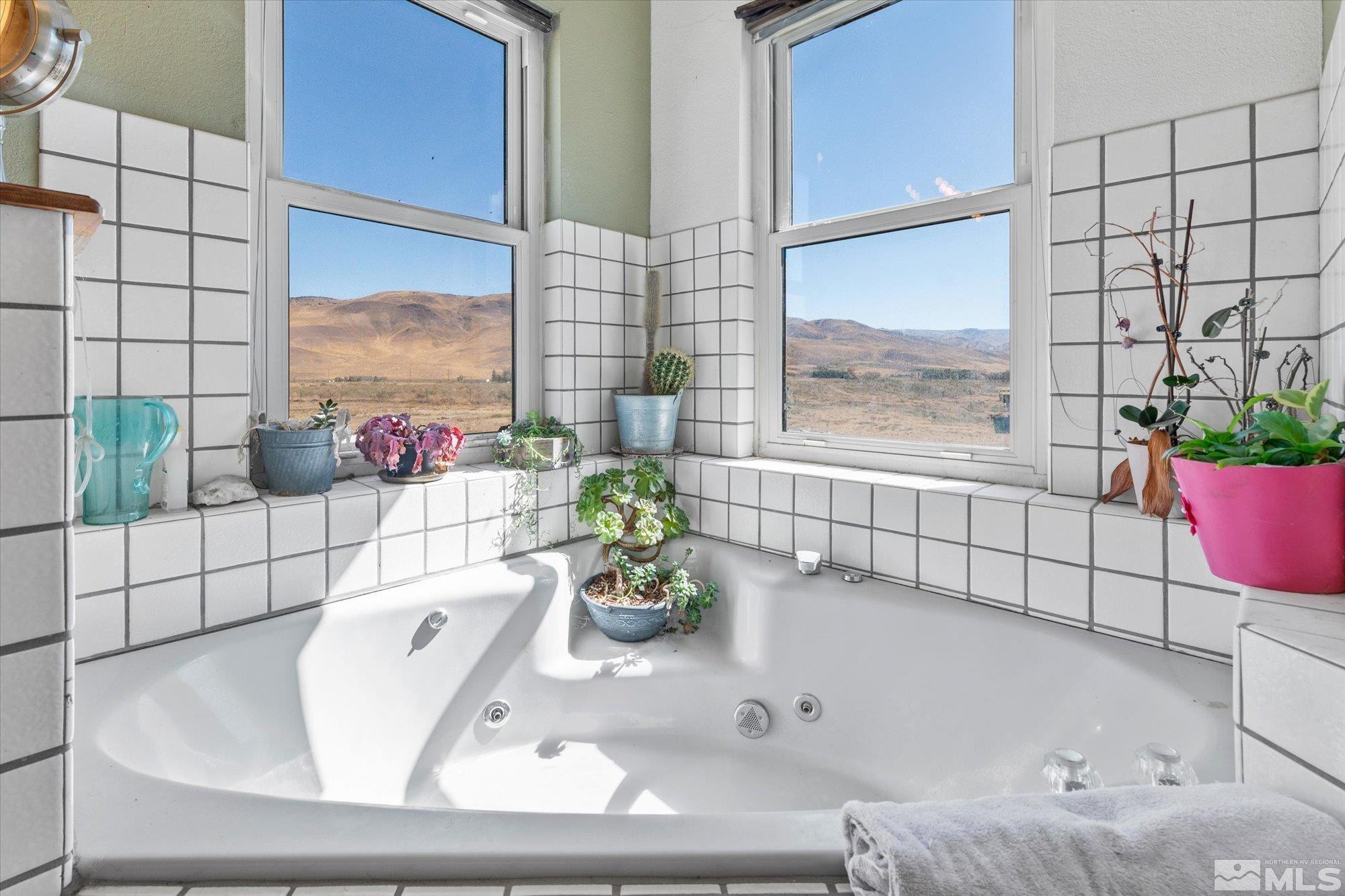 16300 Pyramid Way Reno, NV 89510 - Photo 24 of 36 a white bath tub sitting next to a window