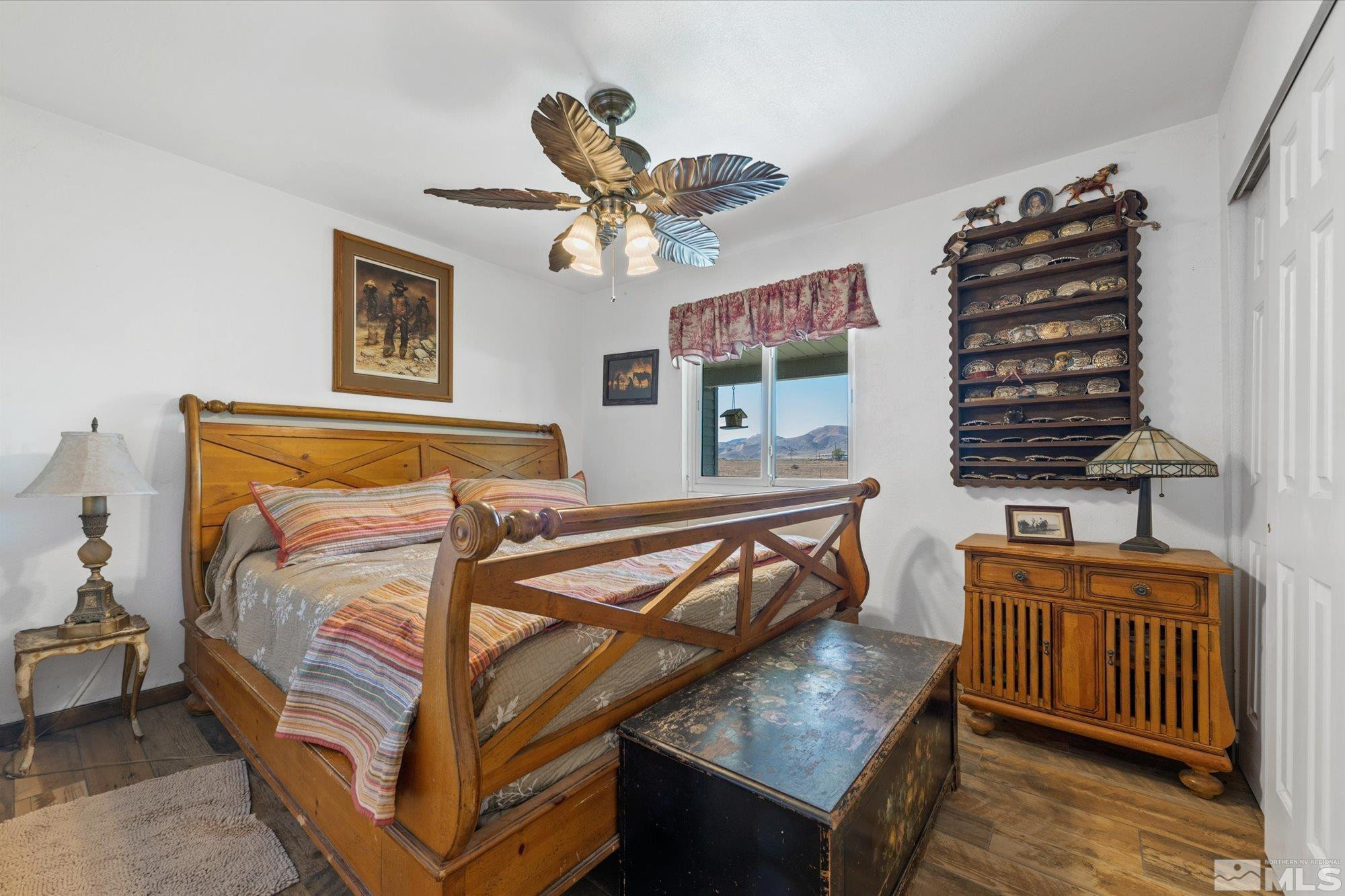 16300 Pyramid Way Reno, NV 89510 - Photo 25 of 36 a bedroom with a bed and a chandelier