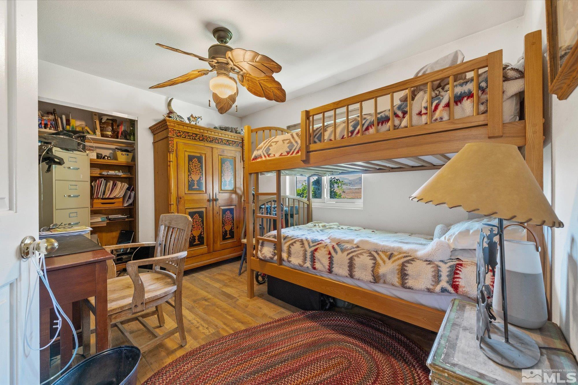16300 Pyramid Way Reno, NV 89510 - Photo 26 of 36 a bedroom with a bed a dresser and potted plants