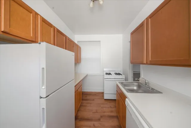 a kitchen with a sink a stove and a refrigerator