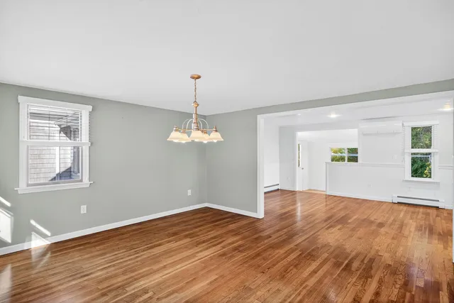 a living room with furniture fireplace and a large window