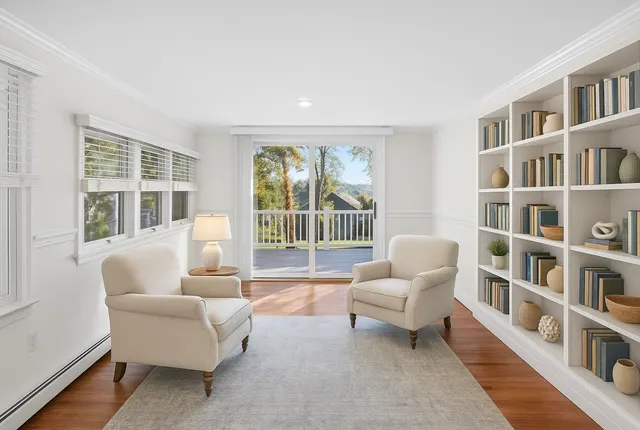 an empty room with sliding glass door and wooden floor