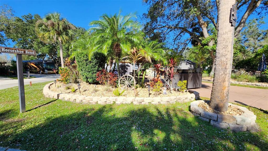 a view of a backyard with plants and outdoor seating