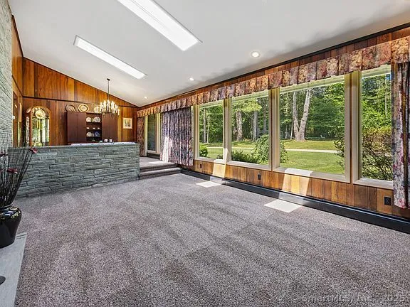 a view of empty room with stairs and wooden floor
