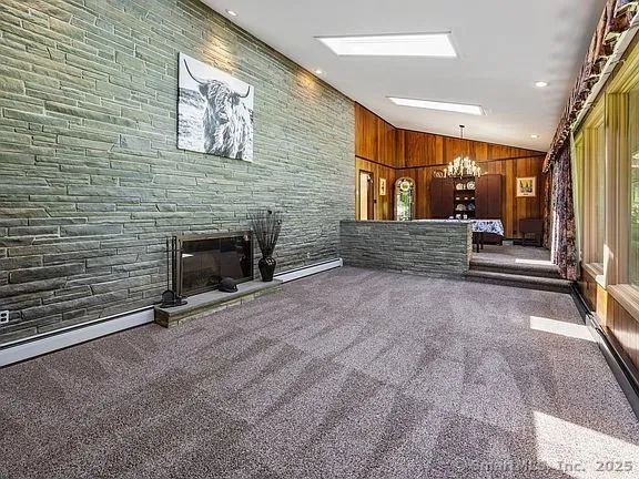 a living room with a clock on wall and a clock