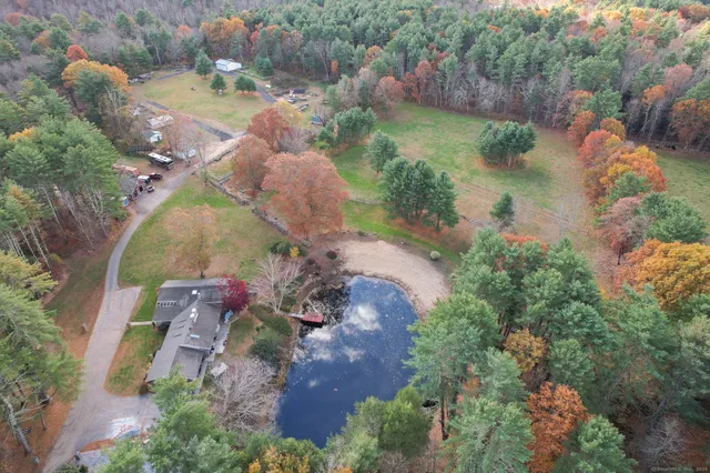 an aerial view of a house with a yard