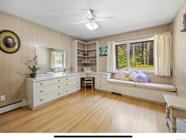 a bedroom with a bed and a bookshelf