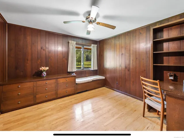 a living room with furniture a wooden floor and a large window