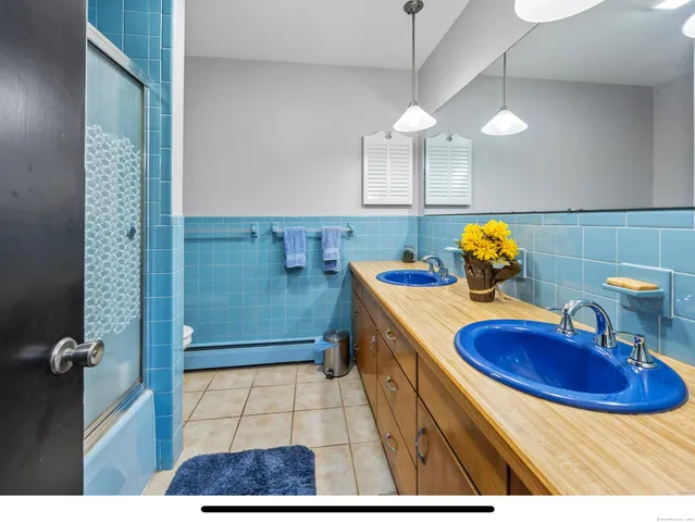 a view of a living room and kitchen with wooden floor