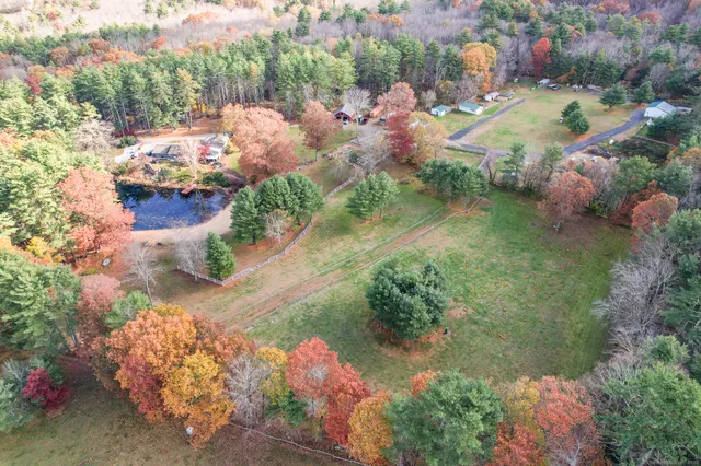 an aerial view of a house with a yard