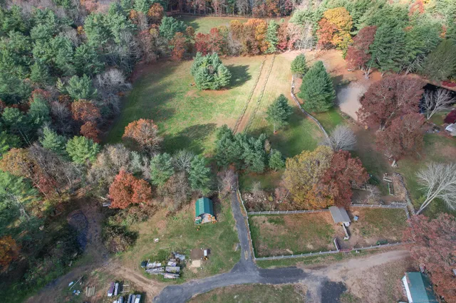 an aerial view of a house with a yard basket ball court and outdoor seating