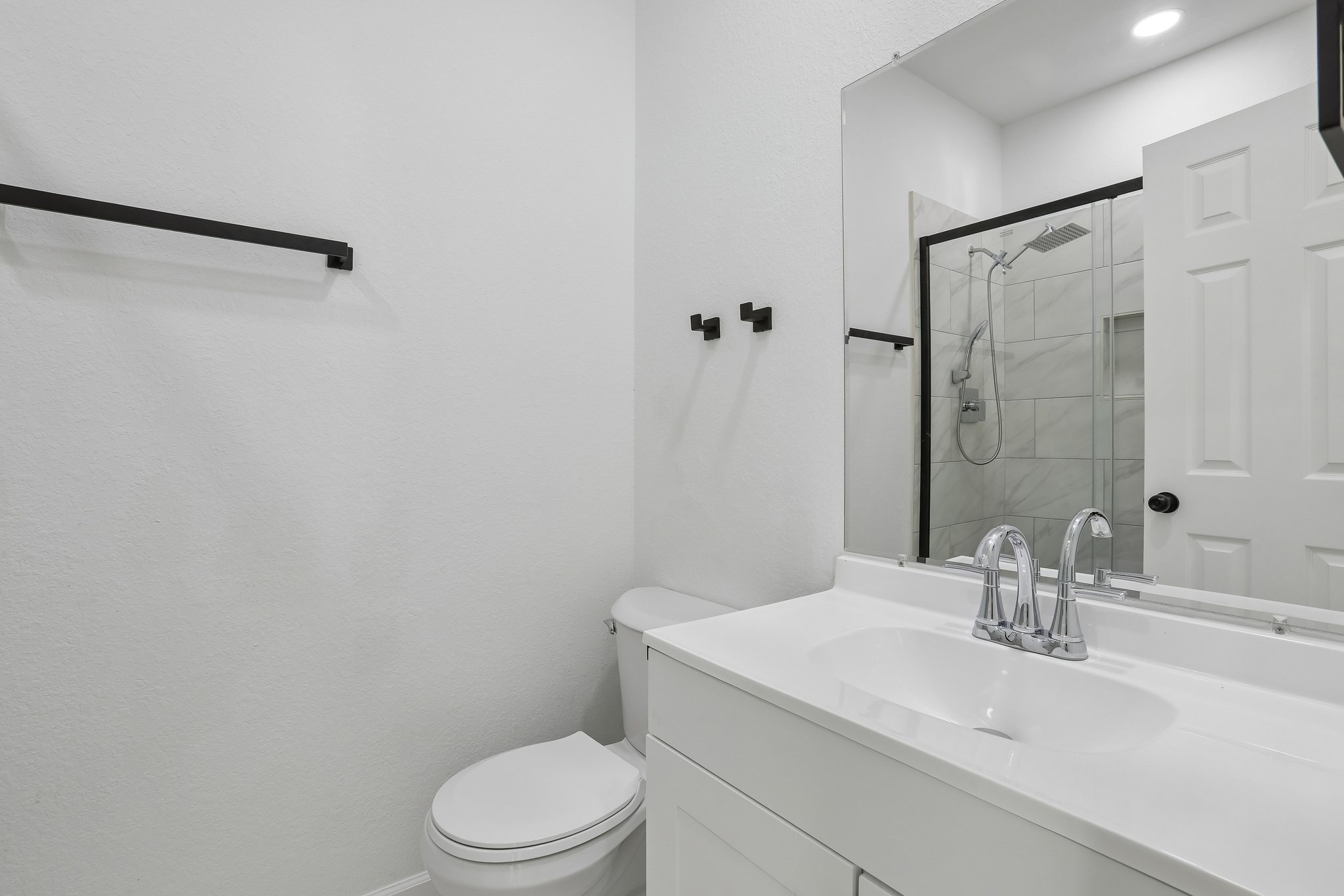 210 Flint Ridge Street Bastrop, TX 78602 - Photo 22 of 40 a bathroom with a sink a toilet and shower