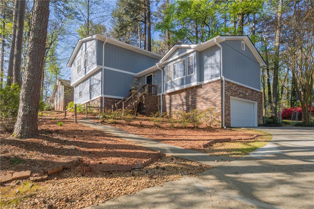 215 Hauteur Place Southwest Lilburn, GA 30047 - Photo 1 of 12 a view of a house with a yard