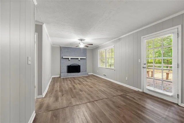 a view of empty room with window and fireplace