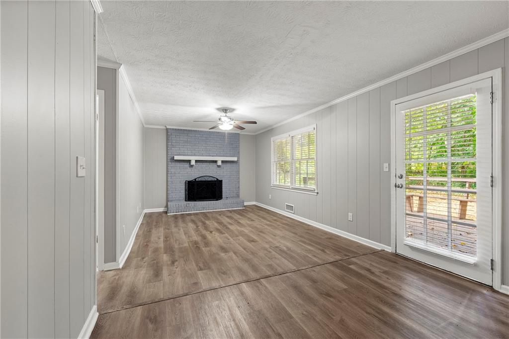 215 Hauteur Place Southwest Lilburn, GA 30047 - Photo 5 of 12 a view of empty room with window and fireplace
