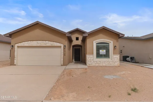 a front view of a house with a garage
