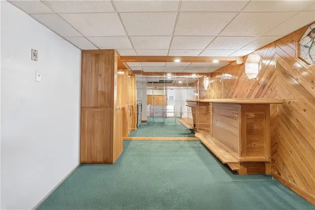a bathroom with a granite countertop sink mirror and a shower